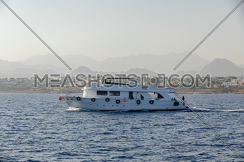 Long shot for yacht sailing showing Sharm El Shaikh City by day