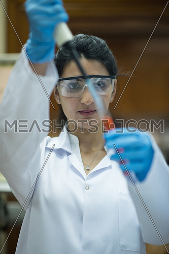 Young middle eastern woman doing a bit of research testing the samples in modern laboratories