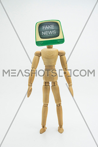 Articulated doll with television head appears fake news, isolated in white background, conceptual image