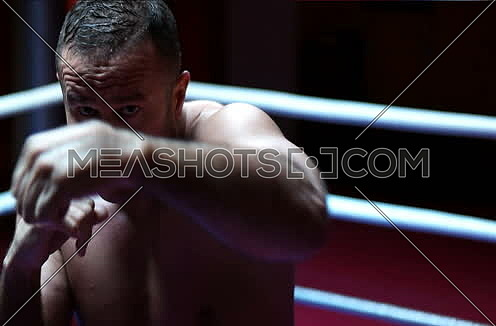 Portrait Of  Fighter or Boxer Throwing Punches Towards Camera