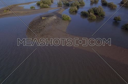 Drone shot flying above lagoon at Day 