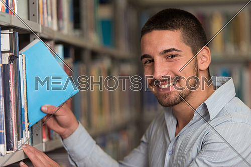 A Portrait Of An Caucasian College Student Man In Library - Shallow Depth Of Field