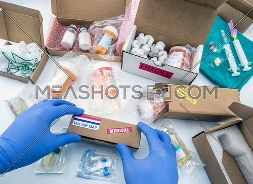 Nurse unpacking medication in boxes, conceptual image, horizontal composition