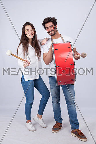 A young couple isolated on white cheering for Egypt