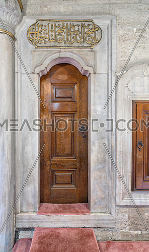 Wooden aged engraved door and marble wall, Eyup Sultan Mosque, Istanbul, Turkey