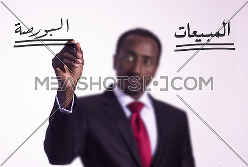 African man writing with a marker on virtual screen in arabic