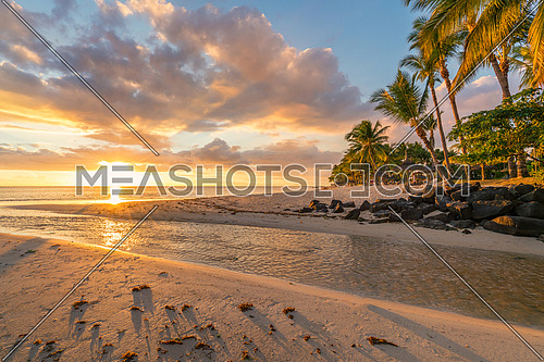 Flic and flac beach at sunset in Mauritius island.