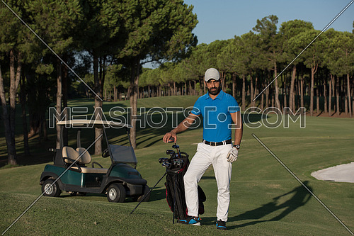 handsome middle eastern golfer portrait at golf course at sunny day