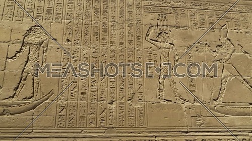 Follow Shot for hieroglyphics writings on a wall inside the Temple of Edfu Egypt.