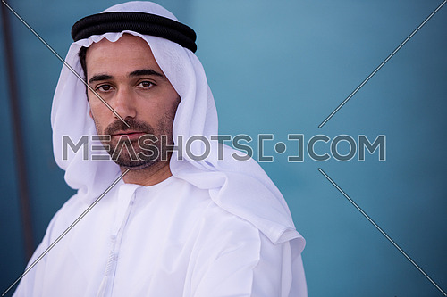 Portrait of happy young arab business man isolated on white background
