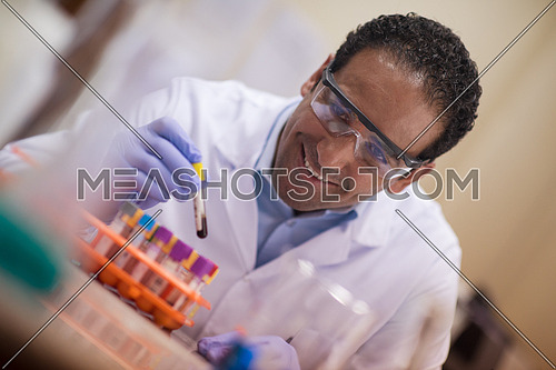 Young middle eastern man doing a bit of research testing the samples in modern laboratories