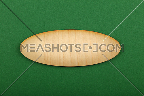 Ellipse shaped blank wooden sign with copy space in center of green design paper background, title slide template