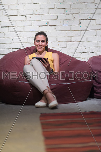 young middle eastern informal business woman enjoys in the creative office using tablet computer