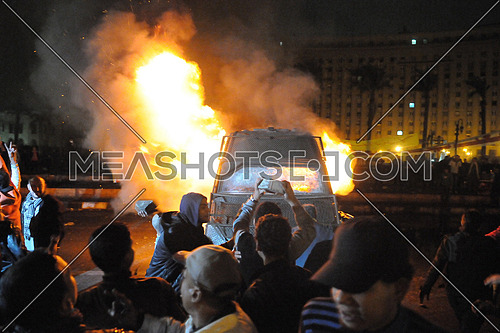 Demonstrators set fire to a central security vehicle in Tahrir Square - Cairo on 28 January 2013