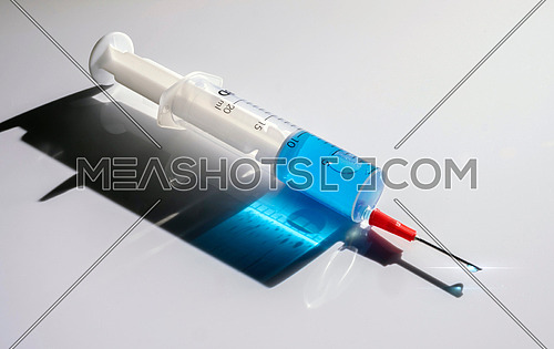 Syringe with medication, conceptual image, horizontal composition