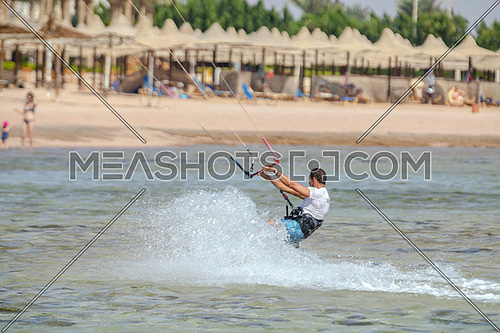 Kite Surfer while surfing in Red Sea at day.
