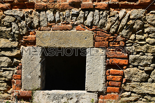 Dark black window in antique brick stone wall