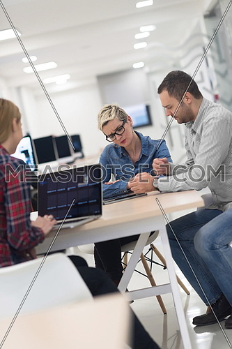 startup business team on meeting in modern bright office interior brainstorming, working on laptop and tablet computer