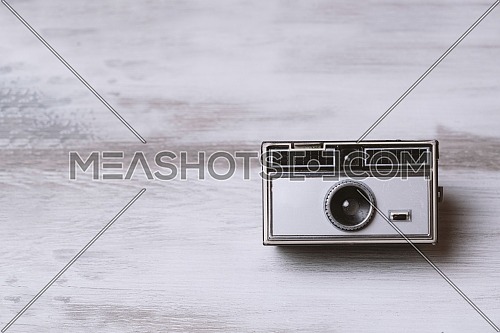 Retro classic 35mm photo camera on gray Background