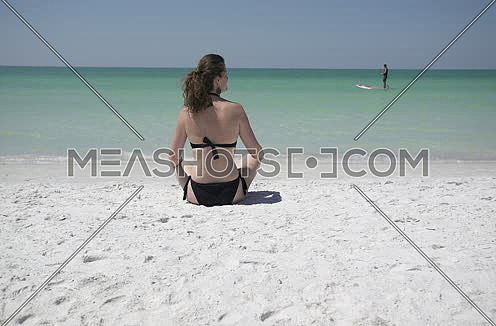 woman relaxing by the beach