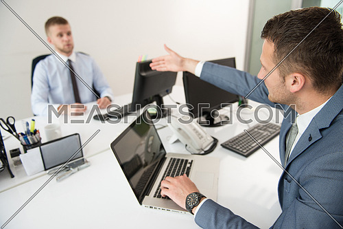 Two Young Businessmen Having An Argument